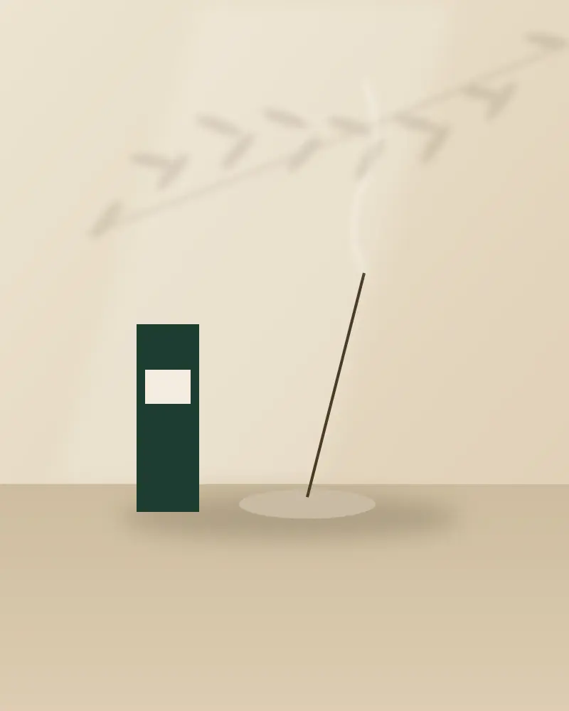 Incense burning beside a green box on a stone table